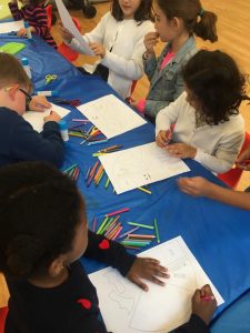 Kids colouring their artwork