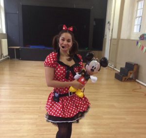 Minney mouse holding Mickey balloon